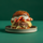 Beast Burger from Burger and Lobster on a plate on a green background