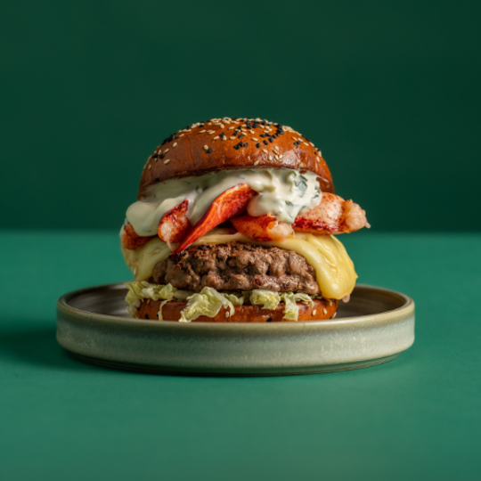 Beast Burger from Burger and Lobster on a plate on a green background